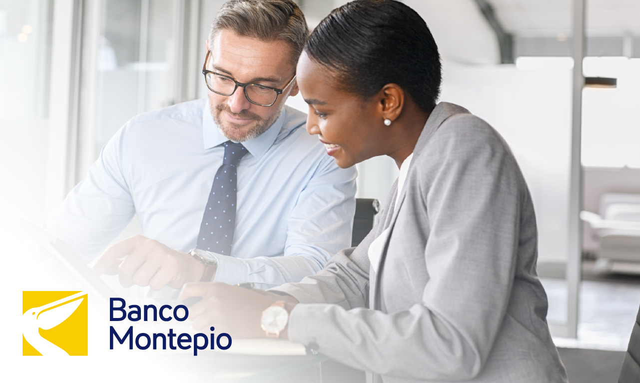 Two professionals collaborating in an office environment, reviewing information on a tablet. The Banco Montepio logo highlights digital modernization in the banking sector and customer-centricity.