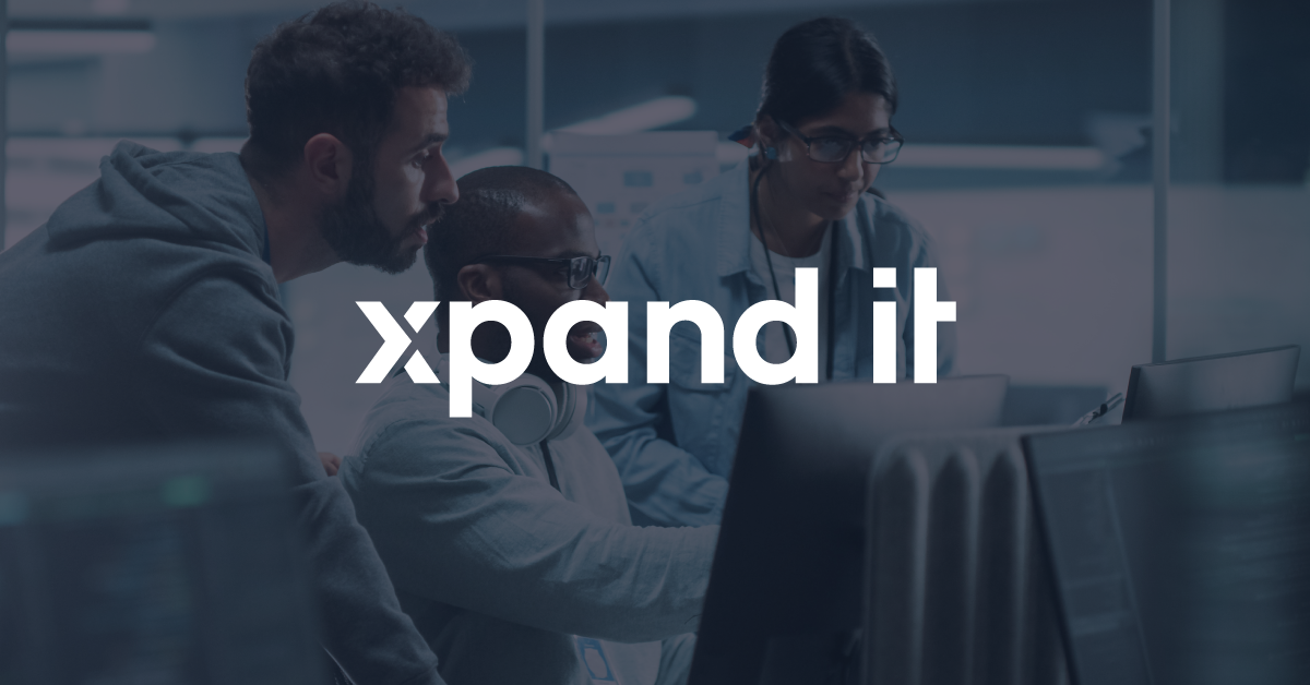 A team of three tech professionals collaborating in a modern office environment, focused on software development and digital innovation.