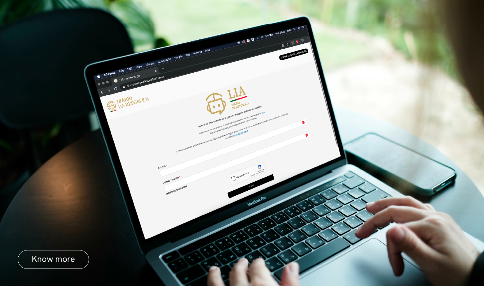Person using a laptop with the login page of the LIA intelligent assistant from Diário da República visible on screen. A button reading “Know more” appears in the bottom left corner.